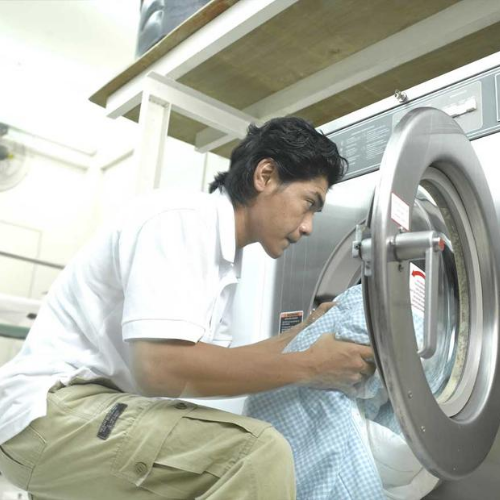 featured image mr clean staff putting laundry into washing machine