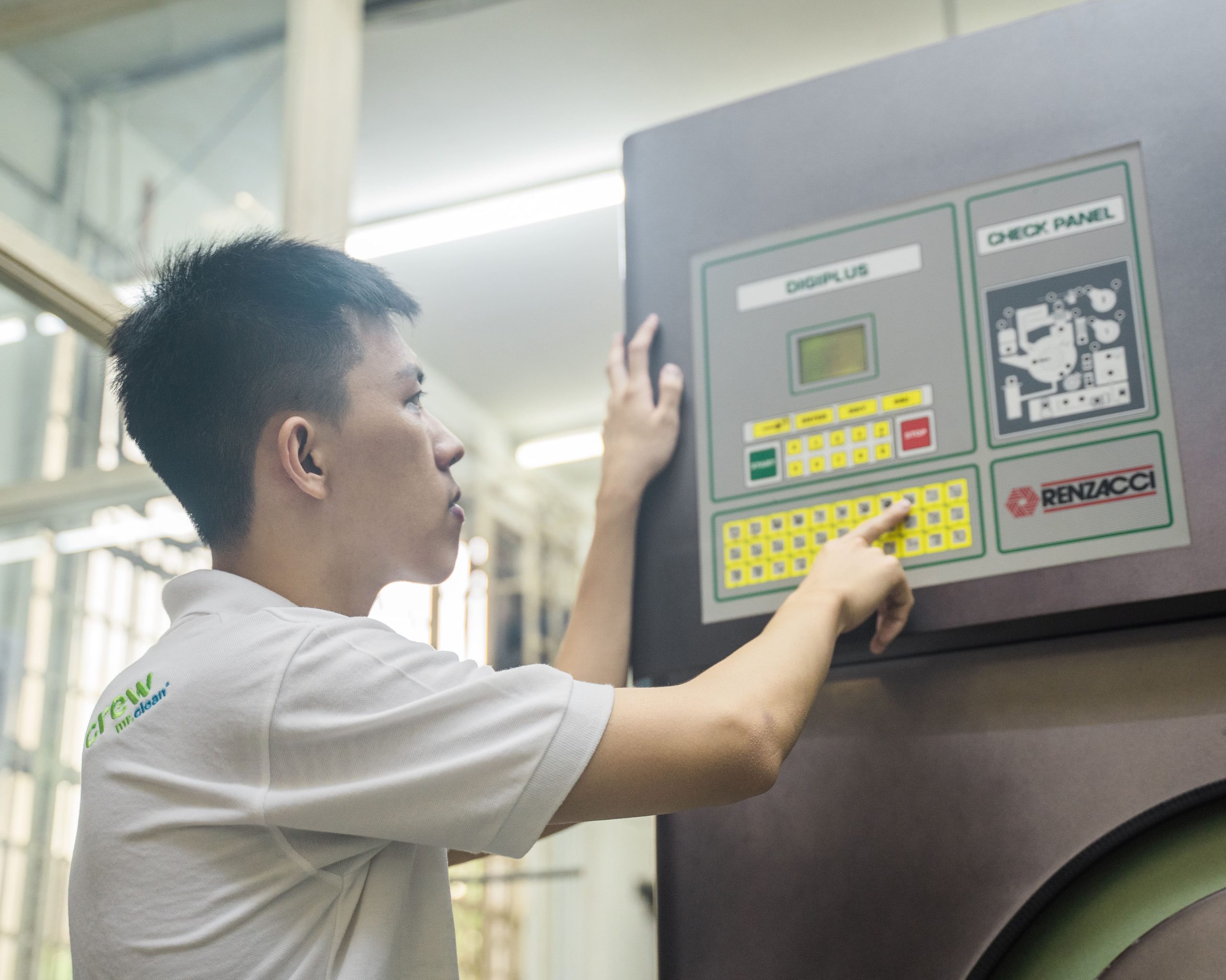staff doing dry cleaning machine setting