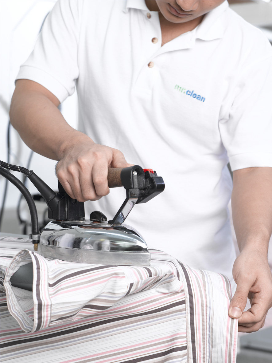 ironing mr clean staff is ironing shirt