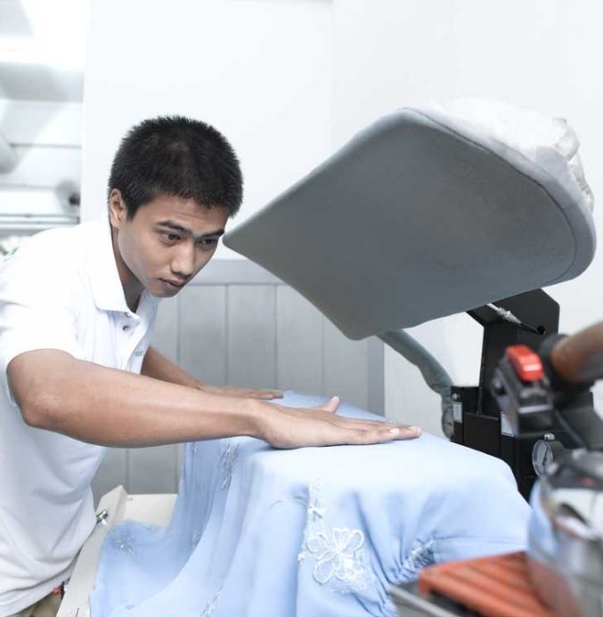 finishing staff is pressing the cloth