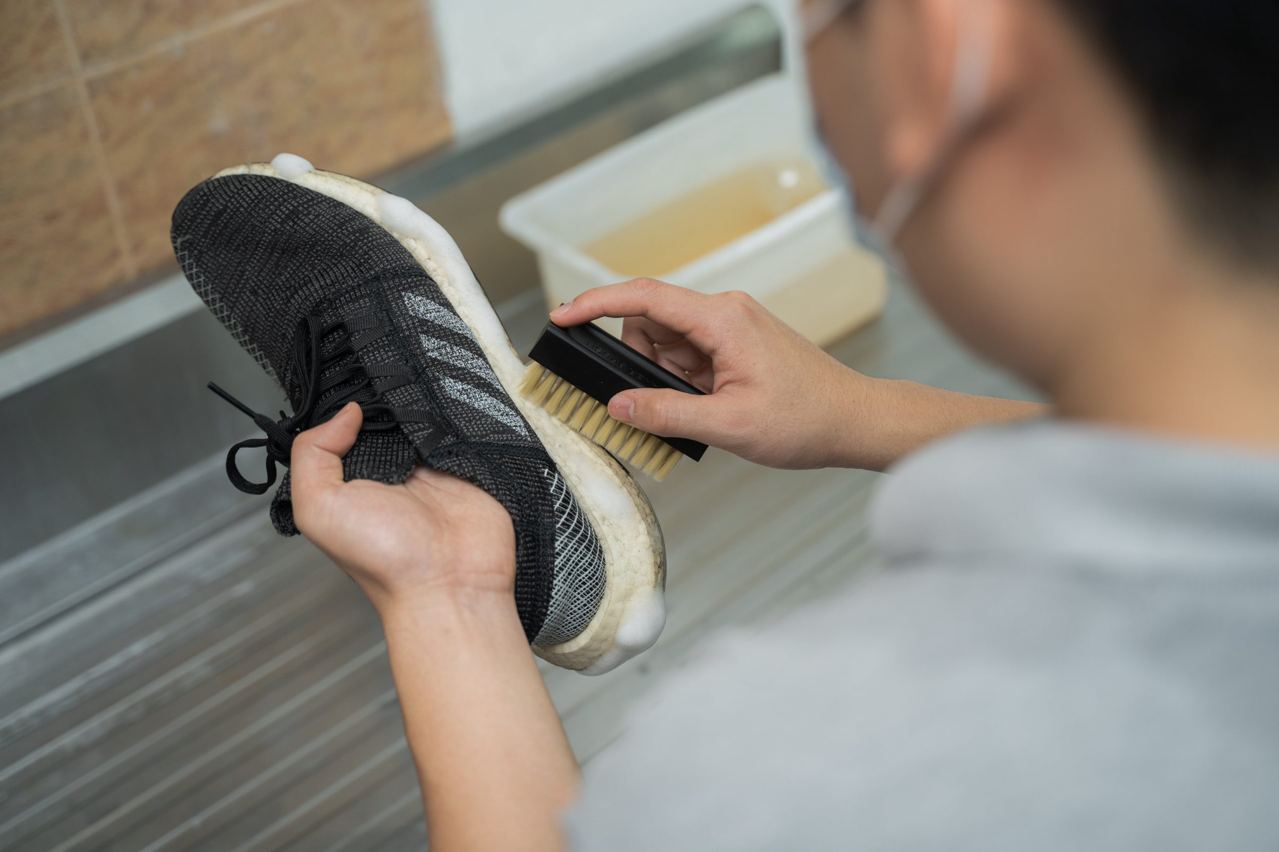 staff is cleaning the shoe with brush