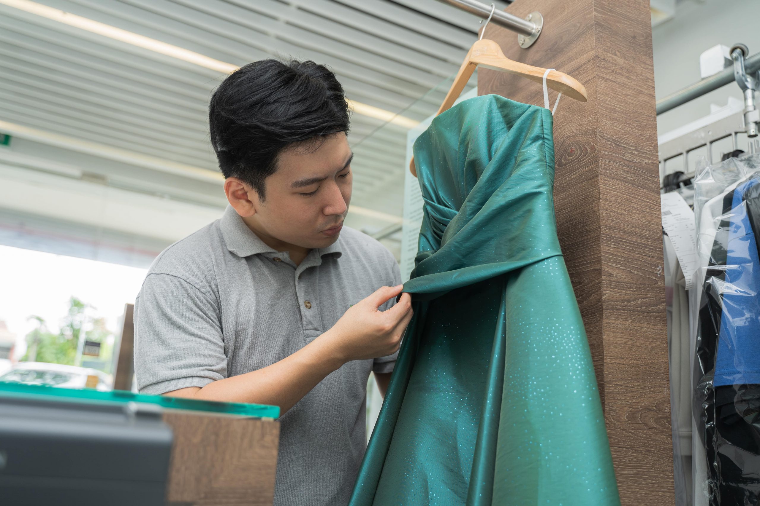 staff inspects the gown carefully