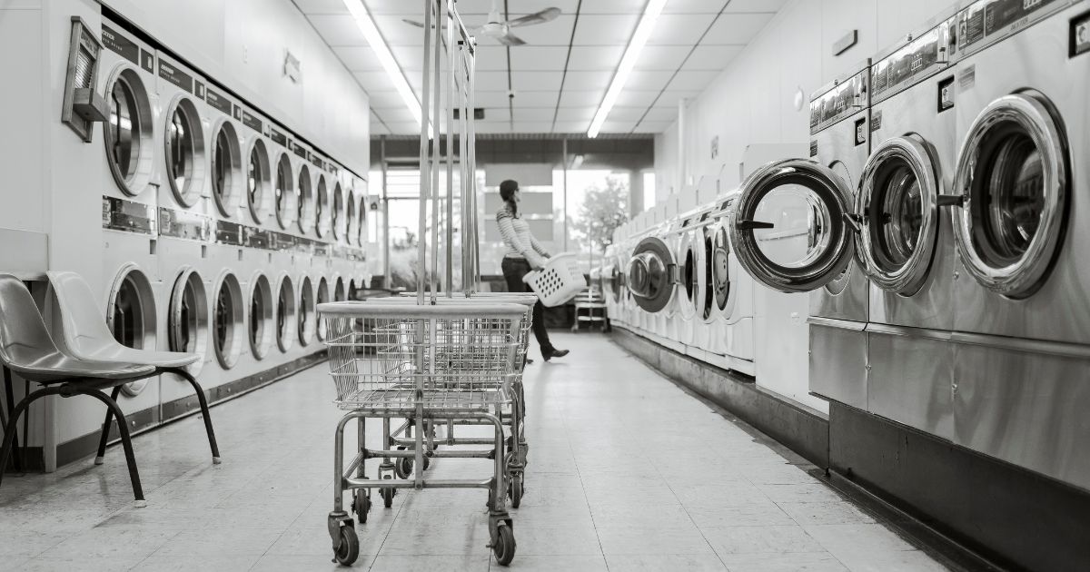 a woman is carrying a laundry basket inside the coin laundry shop – facebook a woman is carrying a laundry basket inside the coin laundry shop