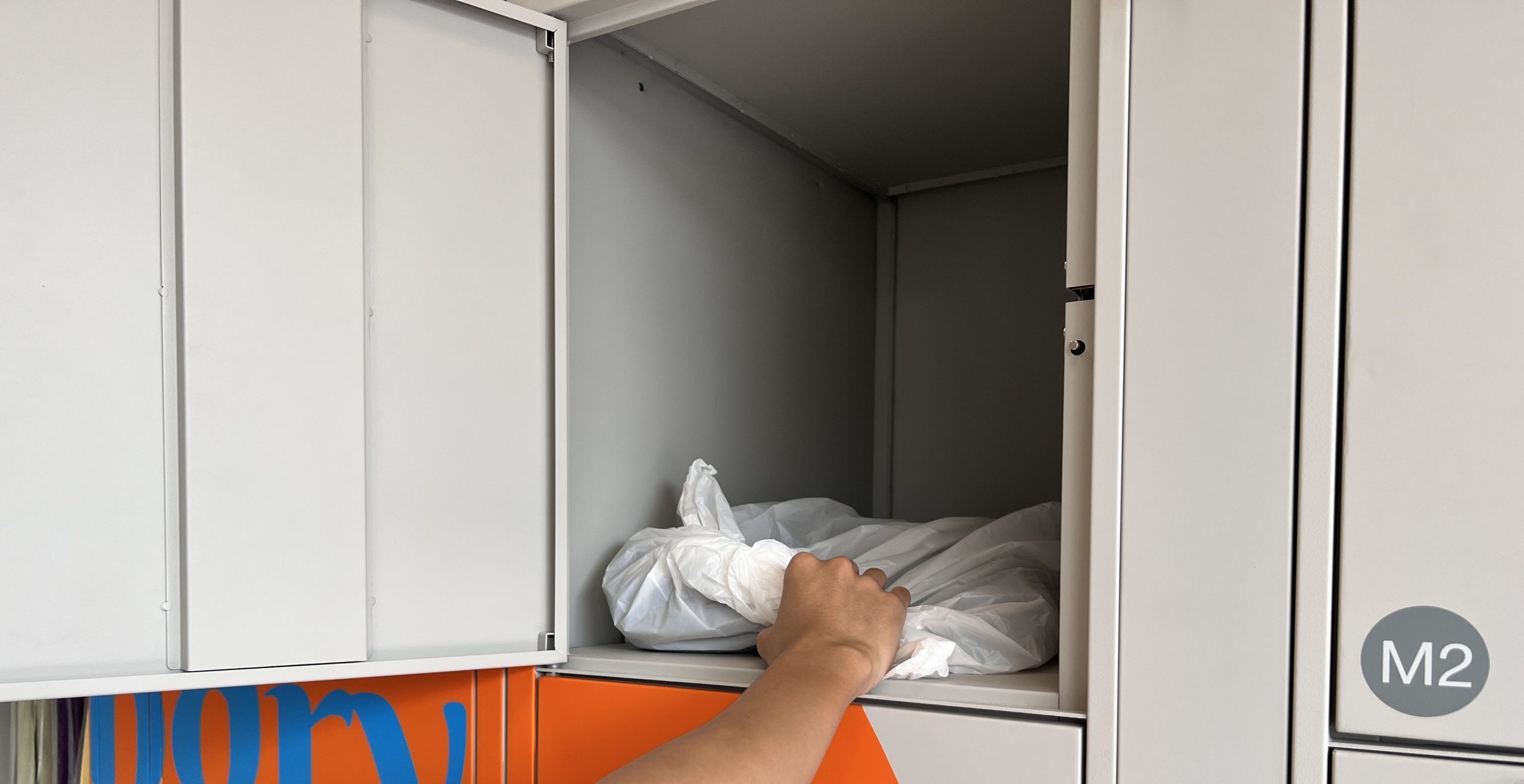 customers putting dirty shirt into the laundry locker customers putting dirty shirt into the laundry locker