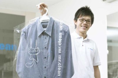 mr clean staff holding a shirt on hanger
