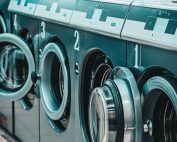 a row of coin laundry machines - Post Featured Image